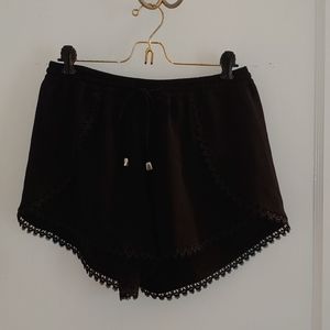 Lacy, flowy black shorts with adjustable waist tie